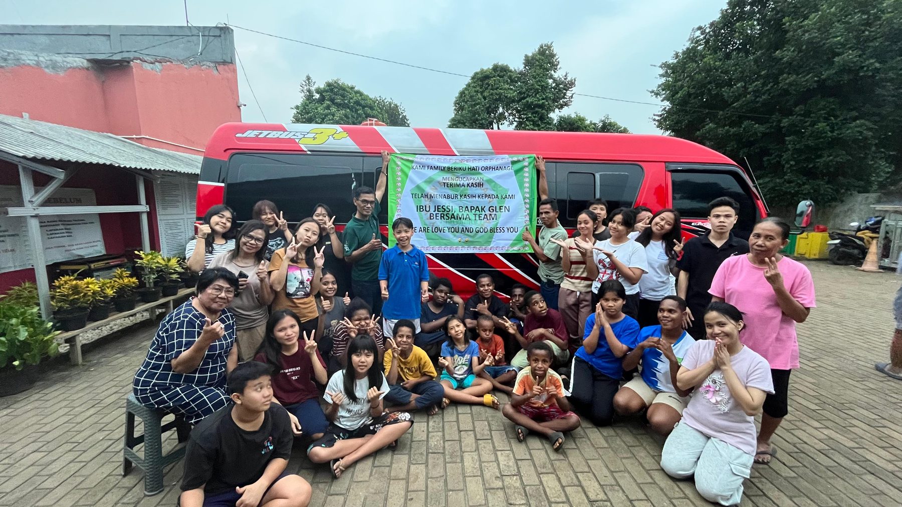BR Academy founders and team with the children and staff of an orphanage in front of their bus