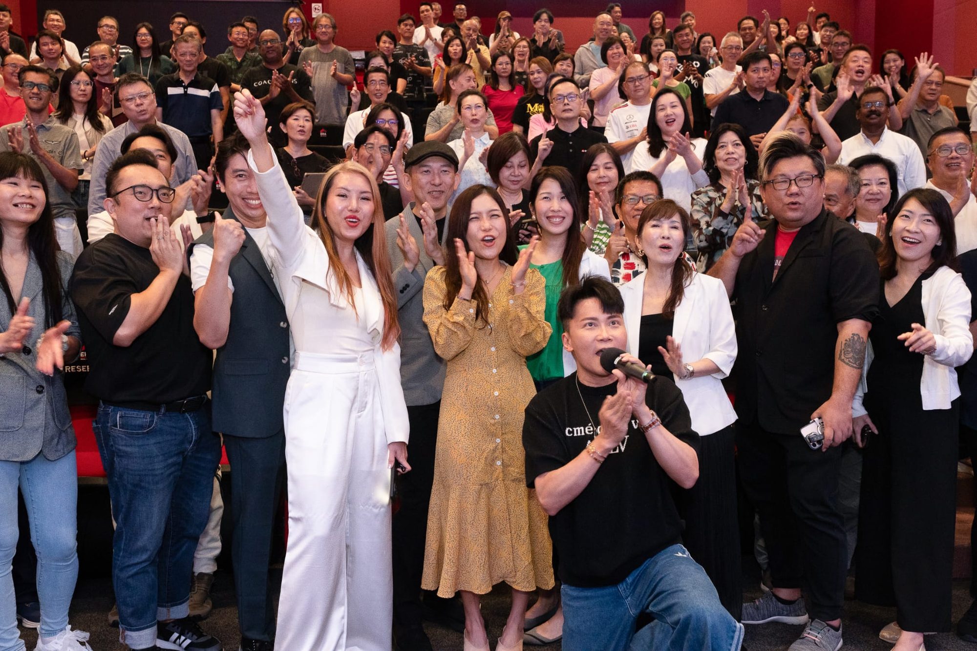 The BR Academy team — Jasmine, Johnny, Glen, Jessie, Paul, Kitty, Cheryl, Tiffany and Joel — celebrating with a graduating class on stage